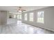 Open-concept living area with abundant natural light, tile floors, and a view of the kitchen and breakfast nook at 1316 Durham Ter, Mcdonough, GA 30252