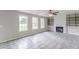 Bright living room with tile floors, a ceiling fan, a fireplace, and built-in shelving at 1316 Durham Ter, Mcdonough, GA 30252