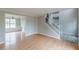 Open-concept living space featuring hardwood floors, staircase and a view into the dining room at 1316 Durham Ter, Mcdonough, GA 30252