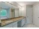 Bathroom featuring double sinks with granite counters, framed mirrors, and natural light at 1316 Durham Ter, Mcdonough, GA 30252