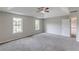 Large main bedroom offering a tray ceiling, a ceiling fan, and plenty of natural light from the two large windows at 1316 Durham Ter, Mcdonough, GA 30252