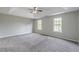 Spacious main bedroom with tray ceiling, fan, and windows offering natural light at 1316 Durham Ter, Mcdonough, GA 30252