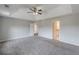 Large main bedroom with a tray ceiling, ceiling fan, and easy access to the en-suite bathroom at 1316 Durham Ter, Mcdonough, GA 30252