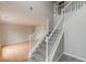 Elegant staircase with white railings leading to the second floor, complemented by hardwood floors at 1316 Durham Ter, Mcdonough, GA 30252