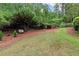 The property offers a large backyard with mature shade trees and park bench at 1431 Waterford Green Dr, Marietta, GA 30068