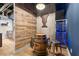 Basement bar area features a custom barrel table, wine fridge, and reclaimed wood accent wall at 1431 Waterford Green Dr, Marietta, GA 30068