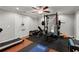Basement gym boasts workout equipment, rubber flooring, and a ceiling fan at 1431 Waterford Green Dr, Marietta, GA 30068