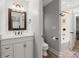 Bathroom features a modern vanity, toilet, and tub-shower combo behind glass door at 1431 Waterford Green Dr, Marietta, GA 30068