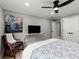 Comfortable bedroom featuring a ceiling fan, a TV, and a sitting area with a stylish chair at 1431 Waterford Green Dr, Marietta, GA 30068