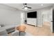 Bright bonus room with hardwood floors, a large TV, and a modern cabinet at 1431 Waterford Green Dr, Marietta, GA 30068