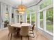 Bright dining room with modern light fixture, large windows, and view of the outdoors at 1431 Waterford Green Dr, Marietta, GA 30068
