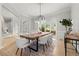 Open dining room with a modern chandelier, rustic table, and an adjacent living space at 1431 Waterford Green Dr, Marietta, GA 30068