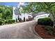 Elegant home with a curved driveway and pristine landscaping at 1431 Waterford Green Dr, Marietta, GA 30068