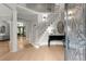 Elegant foyer with a curved staircase, hardwood floors, and a view into the living spaces at 1431 Waterford Green Dr, Marietta, GA 30068