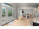 Bright foyer with leaded glass front door, hardwood floors, and views of the formal dining room at 1431 Waterford Green Dr, Marietta, GA 30068