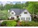 Charming white two-story home with manicured landscaping and a lush green backdrop at 1431 Waterford Green Dr, Marietta, GA 30068