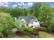 View of a two-story white home with an attractive yard, and mature trees in the background at 1431 Waterford Green Dr, Marietta, GA 30068