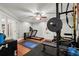 Home gym includes a treadmill, weights, rubber mat flooring, and french door entryway at 1431 Waterford Green Dr, Marietta, GA 30068