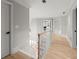 Bright upper hallway with hardwood floors and white staircase at 1431 Waterford Green Dr, Marietta, GA 30068