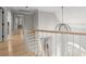 Upstairs hallway features hardwood floors and a curved railing looking down to the main floor at 1431 Waterford Green Dr, Marietta, GA 30068