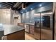 Modern kitchenette featuring stainless steel appliances, dark cabinets, and stylish lighting at 1431 Waterford Green Dr, Marietta, GA 30068