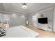 Well-lit main bedroom features tray ceiling, hardwood floors, and a view to a luxurious bath at 1431 Waterford Green Dr, Marietta, GA 30068