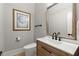 Charming powder room featuring elegant mirror, artwork, and wood vanity with white countertop at 1431 Waterford Green Dr, Marietta, GA 30068