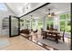 Bright sunroom featuring floor-to-ceiling windows, a view of the backyard, and hardwood floors at 1431 Waterford Green Dr, Marietta, GA 30068