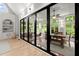 Bright sunroom featuring floor-to-ceiling windows, a view of the backyard, and hardwood floors at 1431 Waterford Green Dr, Marietta, GA 30068