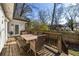 Outdoor dining space with grill featuring a spacious deck, seating, and a tranquil backyard setting at 1598 Olympian Sw Cir, Atlanta, GA 30310