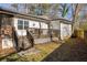 Expansive backyard with a spacious deck, and staircase, surrounded by a well-maintained lawn at 1598 Olympian Sw Cir, Atlanta, GA 30310
