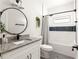 Stylish bathroom features a round mirror, granite vanity, and modern fixtures in a clean design at 1598 Olympian Sw Cir, Atlanta, GA 30310