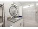 Bright bathroom featuring white tile, a granite-topped vanity, and a shower-tub combination at 1598 Olympian Sw Cir, Atlanta, GA 30310