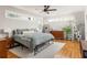Bright bedroom featuring a large window, wood floors, and a comfortable bed at 1598 Olympian Sw Cir, Atlanta, GA 30310