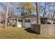 Charming white brick home featuring a quaint porch and a well-maintained fenced yard, perfect for outdoor enjoyment at 1598 Olympian Sw Cir, Atlanta, GA 30310