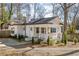 Charming single-story home with a manicured front yard, white brick exterior, and inviting front porch at 1598 Olympian Sw Cir, Atlanta, GA 30310