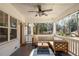 Charming front porch with a cozy seating area, ceiling fan, and serene neighborhood views at 1598 Olympian Sw Cir, Atlanta, GA 30310