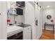 Functional laundry area with washer, dryer, shelving, and stylish sliding barn door at 1598 Olympian Sw Cir, Atlanta, GA 30310