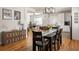 Open floor plan with hardwood floors connecting the living, dining, and kitchen areas at 1598 Olympian Sw Cir, Atlanta, GA 30310