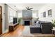 Cozy living room featuring a stone fireplace, hardwood floors, and a large window at 1598 Olympian Sw Cir, Atlanta, GA 30310