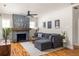 Cozy living room featuring a stone fireplace, hardwood floors, and a large window at 1598 Olympian Sw Cir, Atlanta, GA 30310