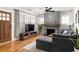 Cozy living room featuring a stone fireplace, hardwood floors, and a large window at 1598 Olympian Sw Cir, Atlanta, GA 30310