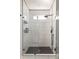Modern shower with glass enclosure, black fixtures, and stylish tile work at 1598 Olympian Sw Cir, Atlanta, GA 30310
