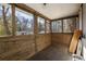 Relaxing sunroom with wood paneling, tile floors, and views of the landscaped backyard and neighborhood at 1598 Olympian Sw Cir, Atlanta, GA 30310