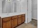 Bathroom vanity with wood cabinets, white countertop, and large mirror over the sink at 209 Woodmill Sw Way, Atlanta, GA 30331