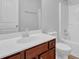 Well-lit bathroom featuring a cherry wood vanity, white countertop, and shower-tub combo at 209 Woodmill Sw Way, Atlanta, GA 30331