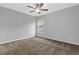 Cozy bedroom features a ceiling fan, plush carpet, and natural light from the window at 209 Woodmill Sw Way, Atlanta, GA 30331