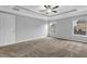 Spacious bedroom featuring plush carpeting, tray ceilings, neutral paint, and abundant natural light at 209 Woodmill Sw Way, Atlanta, GA 30331