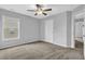 Bedroom with neutral paint and carpet, ceiling fan, window and a closet at 209 Woodmill Sw Way, Atlanta, GA 30331