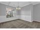 Dining room featuring large window, neutral colors, and decorative chandelier at 209 Woodmill Sw Way, Atlanta, GA 30331